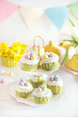 Green Easter cupcakes with colourful eggs