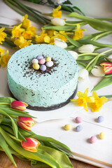 Obraz na płótnie Canvas Easter pastel robins egg cheesecake and spring flowers