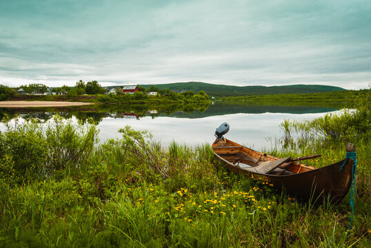 A wooden boat on a Karasjohka river bank in Karasjok, Norway