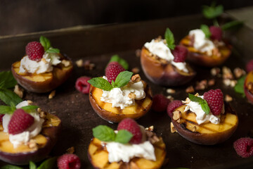 Dark mood grilled summer peaches with cream, raspberries & honey