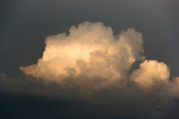White yacht on sea surface and storm clouds