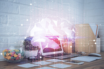 Double exposure of work space with computer and human brain drawing hologram. Brainstorm concept.