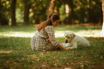 A young woman and her guard dog together in nature, resting in the shade