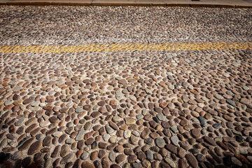 Closeup of an old road made with small cobblestones in Padua downtown, Veneto, Italy, southern Europe.