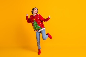 Full size photo of crazy funky girl dance x-mas newyear party wear christmas tree decor jumper jeans boots isolated over bright shine color background