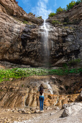 Girl tourist admires the waterfall