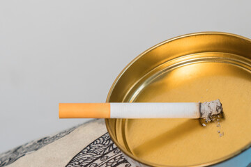 Lighted cigarette on an ashtray