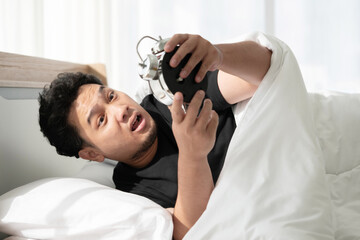 Fototapeta premium A Man Wake Up in the Morning By His Bed Side Alarm Clock