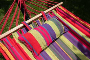 Fototapeta na wymiar empty hammock in a green bright garden.