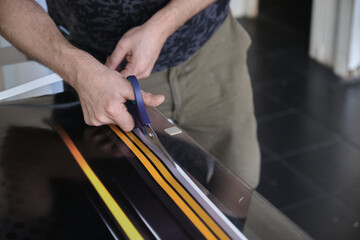 Man cutting print paper with scissors
