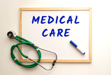 There is a stethoscope on a white board background and the word is written. Medical concept.