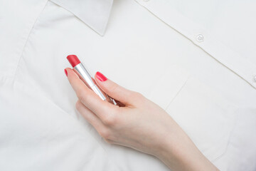 Mistress with red lipstick, female hand write on shirt, white male shirt, closeup, copy space, top view