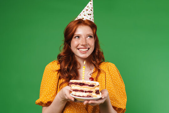 Image of ginger happy girl smiling while holding birthday cake