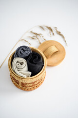 Men's socks in a round box on a white background - close-up