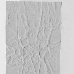White torn paper collage close-up. Texture made from various paper and cardboard parts. Damaged old paper background. Vintage blank wallpaper. Material design backdrop.