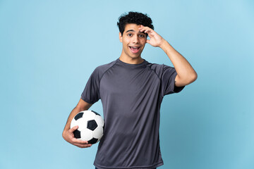 Venezuelan football player man over isolated background with surprise expression