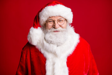 Close up photo of positive santa claus look in camera wear red costume headwear isolated over bright shine color background