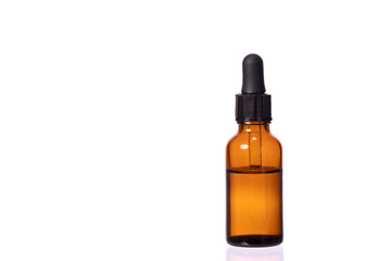 glass cosmetic brown bottle with pipette and clear transparent liquid. Eye or nasal drops isolated...