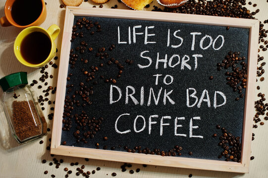 Life is too short to drink bad coffee. Words on blackboard flat lay.