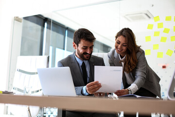 Two employees in the company are consulting about work obligations, they are consulting about new...