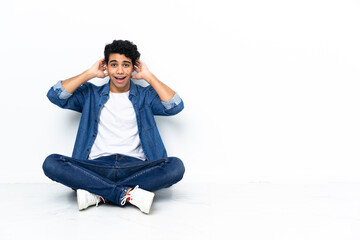 Venezuelan man sitting on the floor with surprise expression
