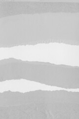 White torn paper collage close-up. Texture made from various paper and cardboard parts. Damaged old paper background. Vintage blank wallpaper. Material design backdrop.