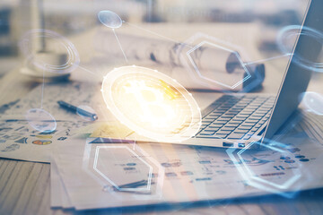Double exposure of blockchain theme hologram and table with computer background. Concept of bitcoin crypto currency.