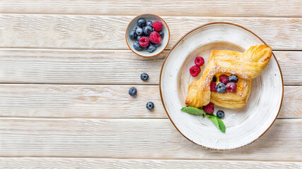 Puff pastry with blueberries and raspberries. Delicious dessert. Long banner with copy space.