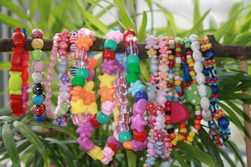 bead bracelets hanging on natural branch