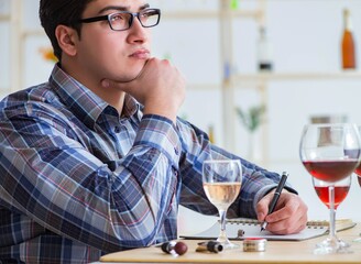 Professional sommelier tasting red wine