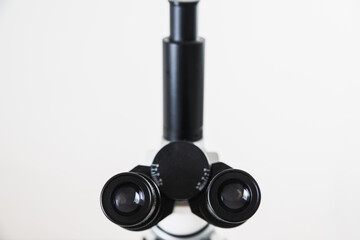 Using a biological microscope. Close up of a microscope. Scientific research concept, using a microscope. Medical examinations, searching for bacteria, diseases, blood tests.
