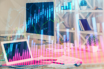 Financial graph colorful drawing and table with computer on background. Multi exposure. Concept of international markets.