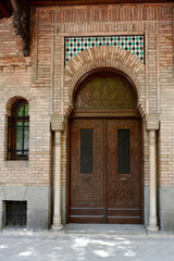 Fototapeta na wymiar Vertical photo of classical double door in Valencian style downtown of Madrid, Spain