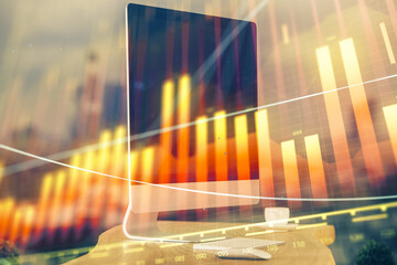 Forex market chart hologram and personal computer background. Multi exposure. Concept of investment.