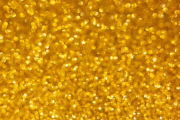 Golden abstract defocused bokeh background. Sparkling texture