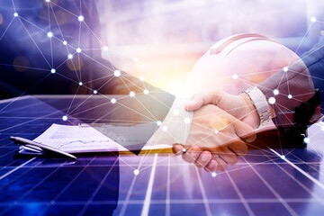 Businessmen are shaking hands for business venture and Marketing on energy. Solar is needed in the...