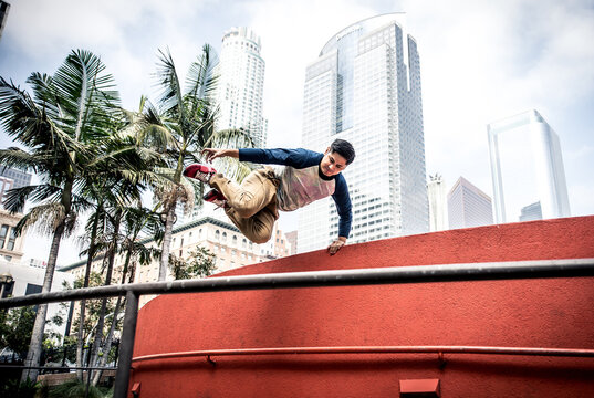  Man performing parkour tricks in the urban center