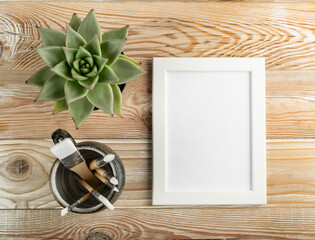 Minimal artist mockup with brushes on wood table flat lay