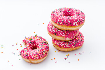 Pink berry donuts close up. Glazed and sprinkles bakery