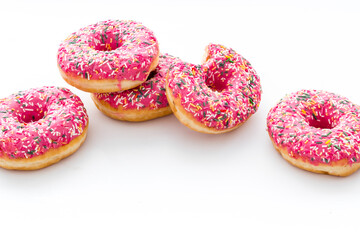Pink berry donuts close up. Glazed and sprinkles bakery