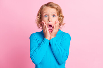Photo of little child arms palms cheekbones scared open mouth wear blue turtleneck isolated pastel...