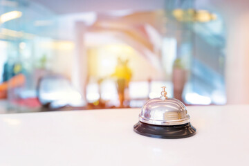Hotel service bell on a table white glass and simulation hotel background