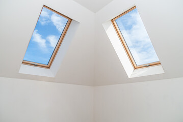 Two windows in the attic ceiling