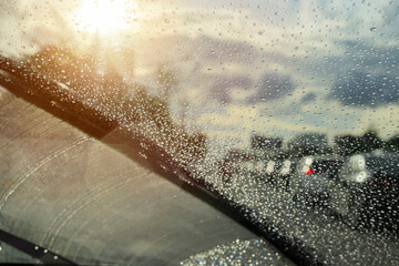 Raindrops closely from the windshield, dark clouds, evening heavy rain