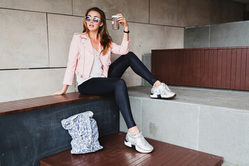young beautiful stylish hipster woman in pink leather jacket, glam rock style, summer trend outfit,...