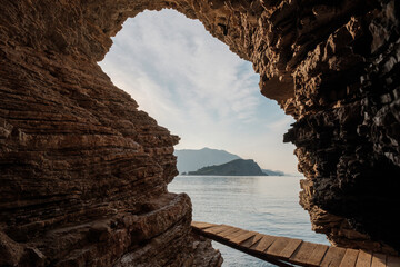 Arch rock at Mogren beach near Old Town Budva in Montenegro.