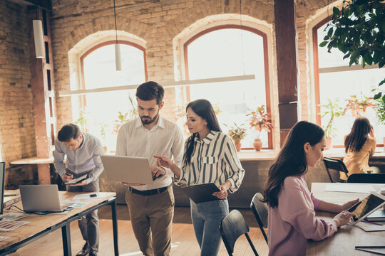 Focused leader coach collar man woman work laptop clipboard have conference decide document start up development aim progress motivation report stand in workplace workstation