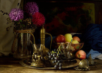 Metal dishes on a wooden table and apples.