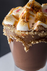Hot chocolate with marshmallows isolated on black background