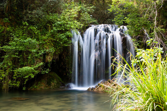 Beautiful waterfall in a pool in a magical environment. Silk effect water in long exposure. Gorg del Mol&iacute; dels Murris, Planes d'Hostoles, Girona, Catalonia, Spain.